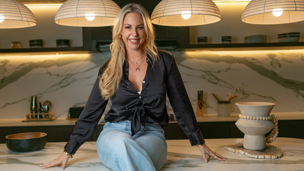 Tatum, founder of Pet Powerhaus, smiling in a modern kitchen